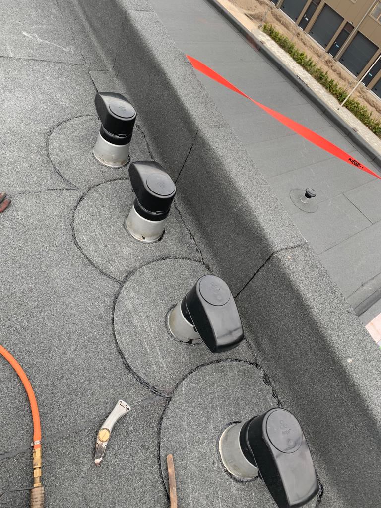 Rij ontluchtingen op een nieuw bitumen dak van een bedrijfspand